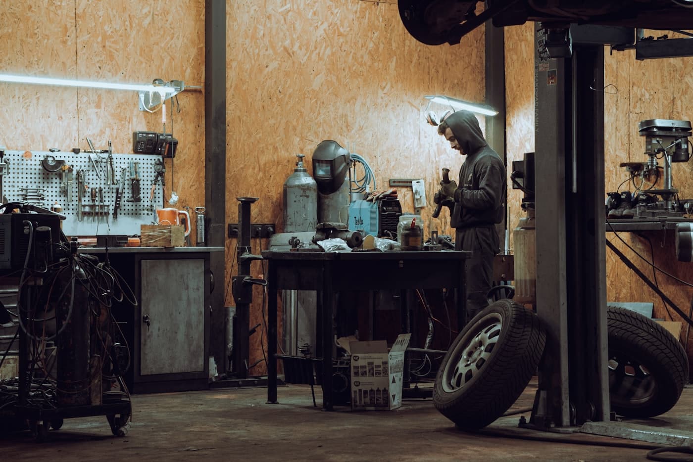 Mechanic working on a car inside a garage